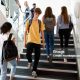 High School Students Walking On Stairs Between Lessons In Busy College Building